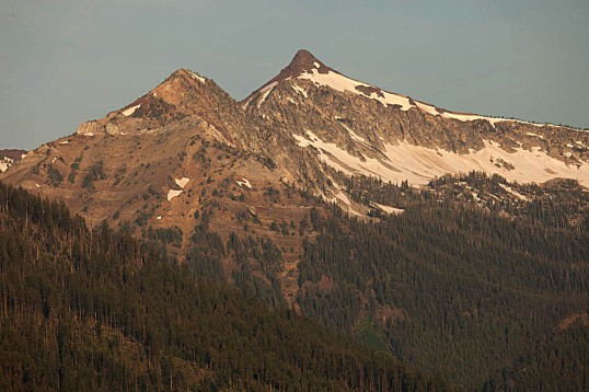 Sawtooth Peak (right) capped by Columbia River Basalt.  Beneath it is granite of the Wallow Batholith --and off to the left, are the bedded rocks of the Martin Bridge Limestone.